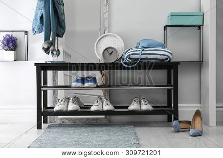 Stylish Hallway Interior With Shoe Rack And Rug