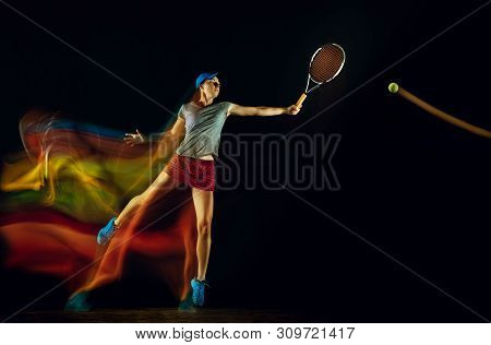 One Caucasian Woman Playing Tennis Isolated On Black Background In Mixed And Stobe Light. Fit Young 