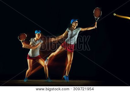 One Caucasian Woman Playing Tennis Isolated On Black Background In Mixed And Stobe Light. Fit Young 