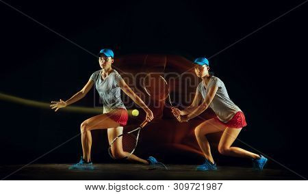 One Caucasian Woman Playing Tennis Isolated On Black Background In Mixed And Stobe Light. Fit Young 
