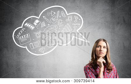 Serious Woman Looks Pensive Upwards And Thinking Something. Speech Bubble Full Of Business Diagrams 