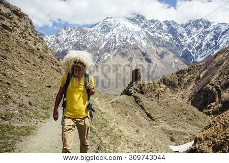 View At Young Hiker With Traditional Papakha Fur Hat At High Latitude Mountains At Mtskheta-mtianeti