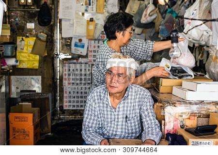 Tokyo, Japan - October 6, 2018. The Asian Couple Does Family Business. Japanese Man And Woman Are Do