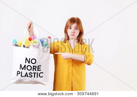 Emotional Redhead Woman Pointing Eco Friendly Shopping Bag With No More Plastic Text, Full Of Harmfu