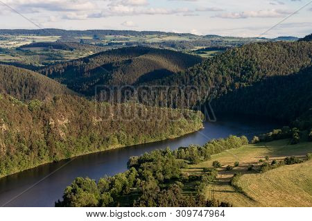 Hilly Wooded Landscape With A Twist Of The River