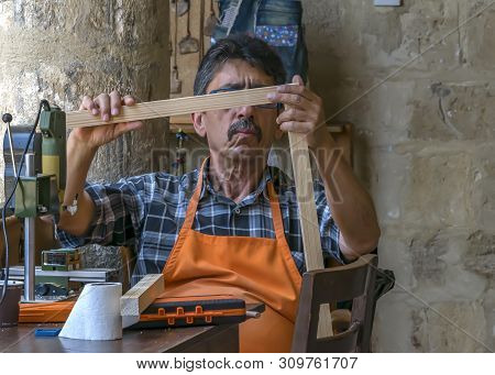 Cyprus, Nicosia - June 10, 2019: Portrait Of Elderly Man 60-75 Years Old Artisan Sitting And And Wor