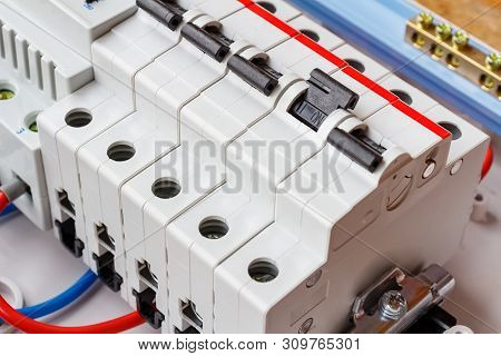 Installed Automatic Circuit Breakers On Din Rail In White Plastic Mounting Box Closeup