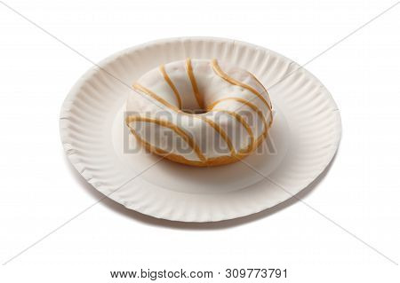 Sweet Doghnut In White Glaze Decorated With Sprinkles On A Paper Plate Isolated On A White Backgroun