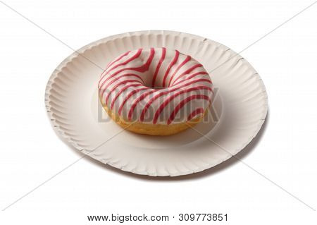 Sweet Doghnut In Pink Glaze Decorated With Sprinkles On A Paper Plate Isolated On A White Background