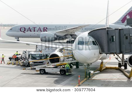 Hamad International Airport, Doha, 2018-05-01: Two Qatar Airline Airplanes At The Airport. Jetway At