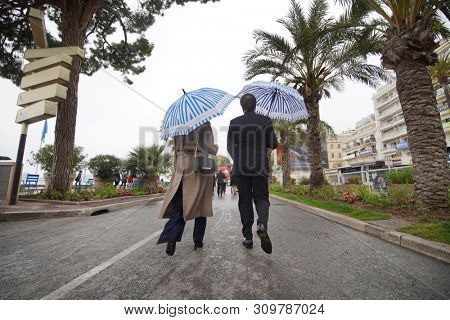 CANNES, FRANCE - MAY 18, 2019: Rain and umbrella details during Promenade de la Croisette of 