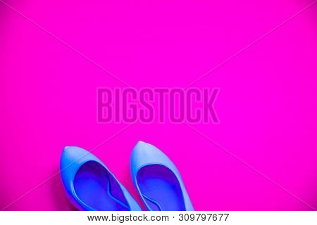 Blue High Heeled Shoes Pink Purple Background - Top View - Heels Pointing Left