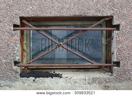 The Basement Window With A Metal Barrier