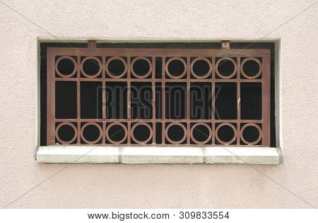 The Basement Window With A Metal Barrier