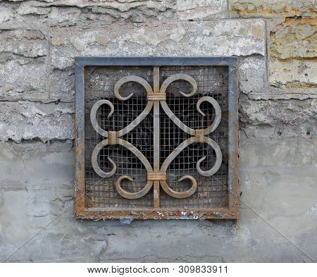 The Basement Window With A Metal Barrier