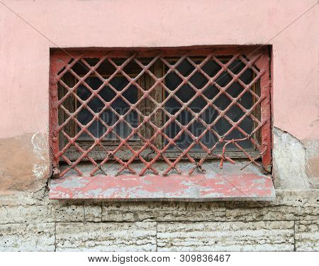 The Basement Window With A Metal Barrier