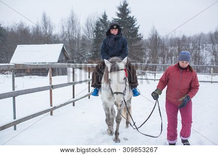PODPOROZHYE, RUSSIA - JAN 21, 2018: Training of children riding in the framework of revival program of the Cossacks in the Leningrad region. Cossacks in St.Petersburg began its revival in 1990.