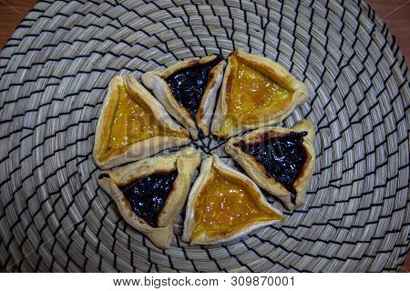 Hamantash Purim Blueberry And Apricot Jam Cookies With Wooden Table Background