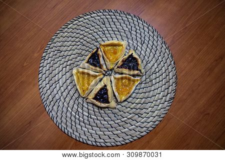 Hamantash Purim Blueberry And Apricot Jam Cookies With Wooden Table Background