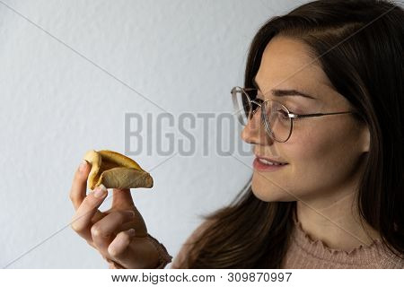 Beautiful And Happy Women Portrait Eating Hamantash Purim Apricot Cookie