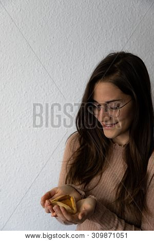 Beautiful And Happy Women Portrait Holding Hamantash Purim Apricot Cookie