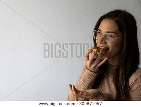 Beautiful And Happy Women Portrait Eating Hamantash Purim Apricot Cookie