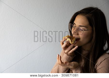 Beautiful And Happy Women Portrait Eating Hamantash Purim Apricot Cookie