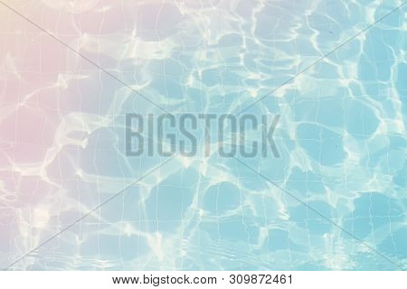 Water Vibrations In The Swimming Pool With Sun Reflection. Blue Swimming Pool Surface, Water Backgro