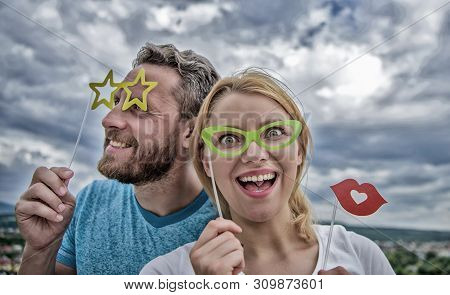 Feeling Playful. Couple In Love Enjoy Party Time On Cloudy Sky. Sexy Woman And Sexi Man Wear Fake Gl