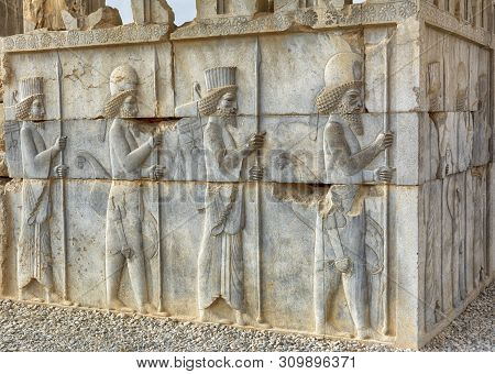 Bas-relief Of Persian Warriors In Persepolis, Iran Was The Ceremonial Capital Of The Achaemenids. Th