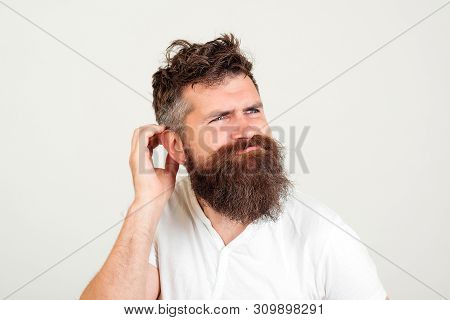 Bearded Hipster Man Thinking. Handsome Guy Thinks Over Future Plans, Being Little Puzzled. Young Bea