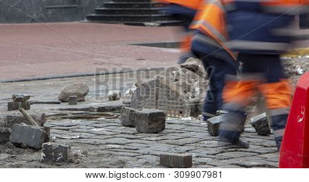 Workers Repair The Road, Pour Small Cracks With Bitumen To Prevent Further Destruction Of The Road S