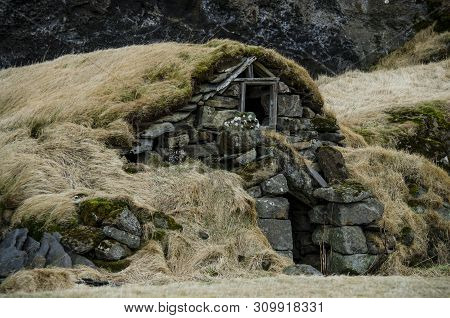 Old Stone House Destroyed Ancient Viking Overgrown With Yellow Dry Grass In Iceland