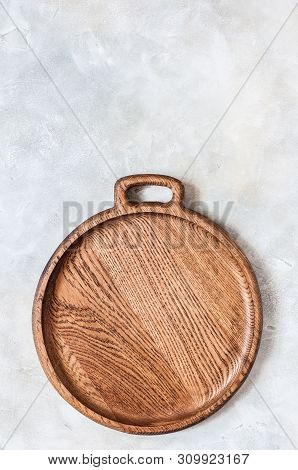 Empty Round Wooden Dish On Grey Concrete Background, Copy Space For Your Text