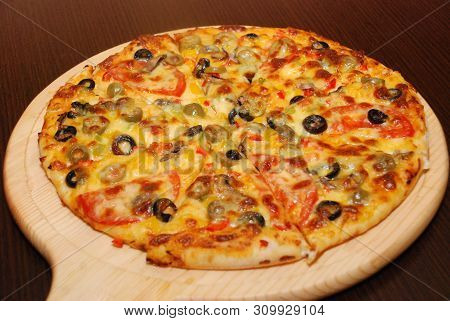 Pizza On The Thin Dough With Cheese And Olives