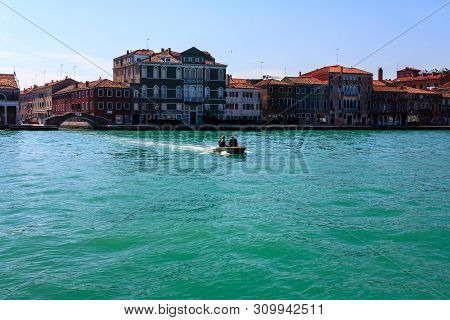 Venice, Italy - March 11, 2012: Boat With Tourists Sails Along The Seashore In Venice. Traditional I