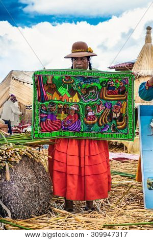 Uros, Peru- Jan 5, 2019: Inhabitants of Uros floating islands sell the rugs, Titicaca lake, Peru.