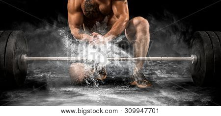 Man clapping hands and preparing for workout at a gym 