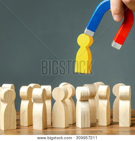 A Hand With A Magnet Pulls Yellow Golden Human Figure Out Of The Big Crowd Of People. Search For Tal