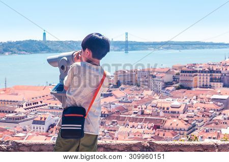 Little Boy Playing With A Binoscope On The Observation Deck Overlooking The Old Town