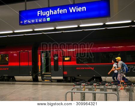 Vienna - June 1 2019: Tourist Rushing To Take An Obb Train At Vienna Airport Train Station