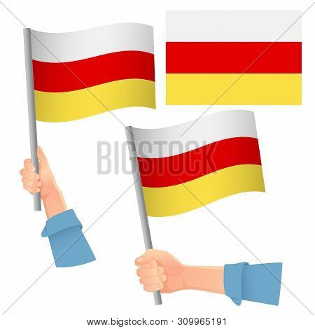 South Ossetia Flag In Hand. Patriotic Background. National Flag Of South Ossetia  Illustration
