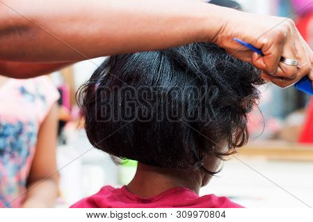 The Hairdresser Creates A Model Of Hair On The Head Of Her Clent.