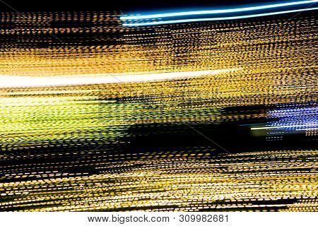 Abstract Of Multicolored Lights Stripes Moving Fast In Dark Background. Orange Violet And Bluel Back