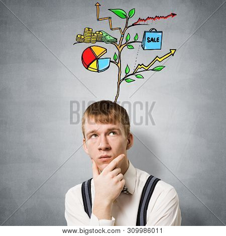Redhead Student Looks Pensive Upwards And Thinking About Some Genius Idea. Clever Boy With Drawing I