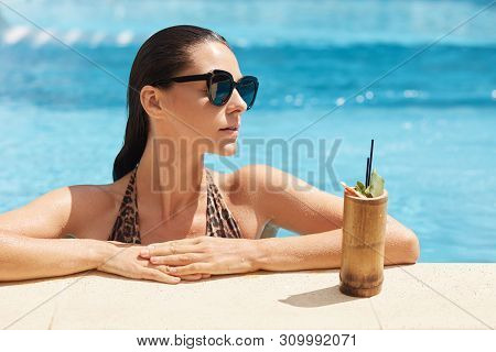 Close Up Portrait Of Young Woman In Swimsuit With Leopard Print Relaxing With Fresh Drink Standing N