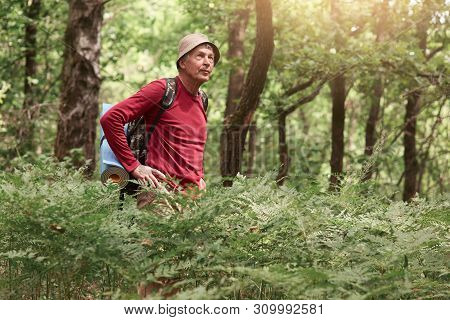 Outdoor Shot Of Thoughtful Pensive Traveller Looking Aside, Being Focused On His Trip, Looking For W