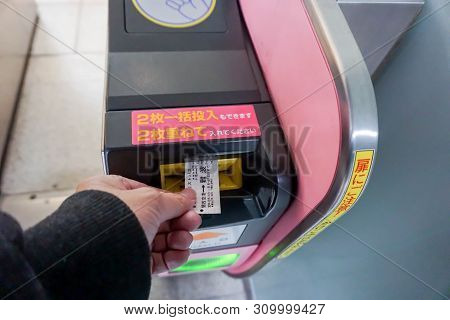 Osaka, Japan-january 13, 2019 : Closeup Hand Of People Insert Subway Ticket In The Entrance Automati