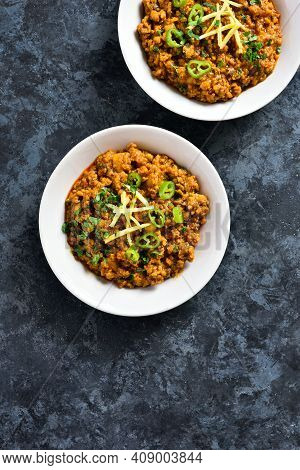 Keema Curry In Bowl Over Blue Stone Background With Copy Space. Indian And Pakistani Style Dish. Top