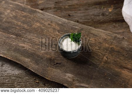 Sour Cream Or Yogurt In Bowl On Wooden Background. Cooking Concept. Close-up.